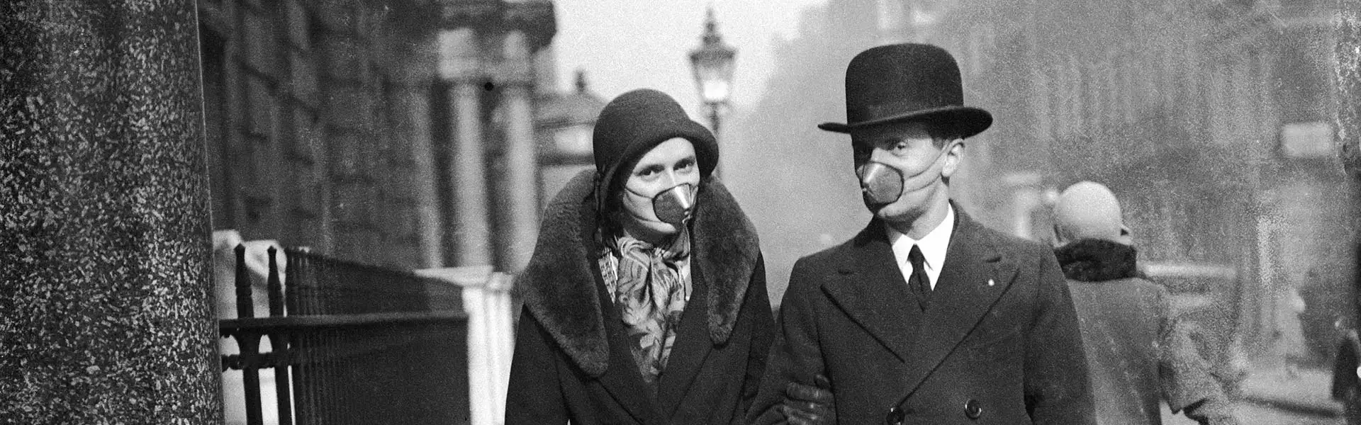 Two people wearing primitive face mask as respiratory protection in 1920's